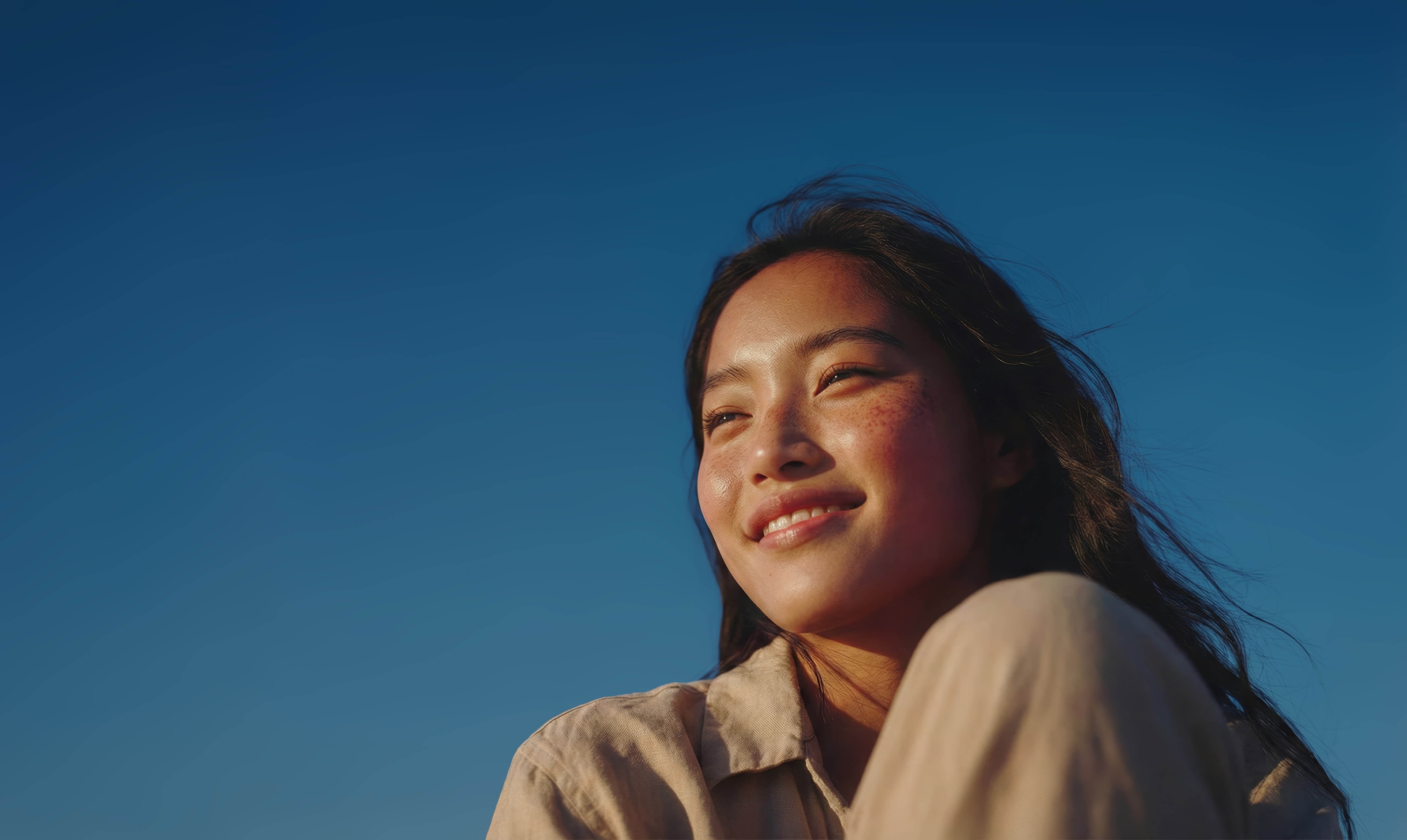 A person smiling in warm sunlight